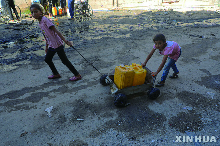2일(현지시각) 가자지구 칸유니스 공동 수도에서 물을 받은 팔레스타인 어린이들이 물통을 끌고 돌아가고 있다. 가자지구 내 팔레스타인 주민들은 건조한 여름, 공급 감소, 황폐해진 기반 시설로 더욱 심각한 물 부족에 시달리는 것으로 나타났다. 유엔 팔레스타인난민기구(UNRWA)는 지난달 소셜미디어 X를 통해 가자지구 내 수도와 위생시설, 기반 시설의 약 67%가 파괴되거나 훼손됐다고 밝혔다. 뉴시스